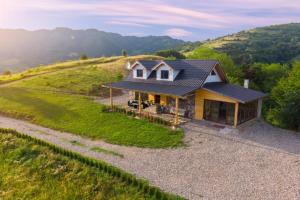 an aerial view of a house on a hill at La Cabană in Vişeu de Jos