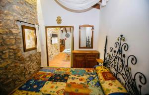 a bedroom with a bed and a stone wall at Casita del Castillo in Denia