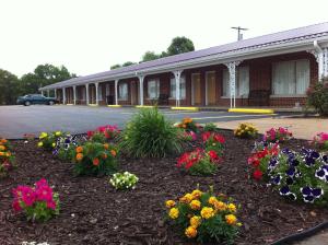 a group of flowers in front of a building at Eldon Inn in Eldon