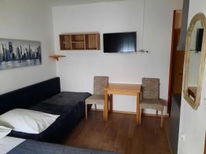 a bedroom with a bed and a table and chairs at Apartments Peričić in Podstrana