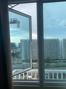 a view of a city from a window at 1 BR CONDO SEA RESIDENCES in Manila