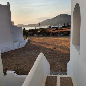 a view from the stairs of a house looking at the ocean at Agiassos Naxos Apartments in Agiassos