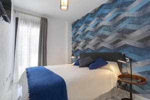 Posteľ alebo postele v izbe v ubytovaní Málaga Rivas 34 Suites Homes