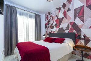 Posteľ alebo postele v izbe v ubytovaní Málaga Rivas 34 Suites Homes