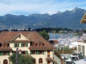 a house with a view of a marina and mountains at Aloha Appartement de vacances au Bouveret in Port-Valais