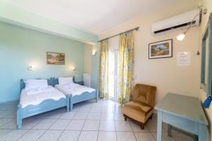 a hospital room with two beds and a chair at Lambrini Studios in Parga +51 photos