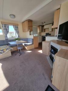 a living room with a kitchen and a living room with a couch at elbry in Heysham