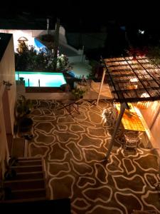 a view of a patio with a swimming pool at night at The Summer Pink House in Lachania