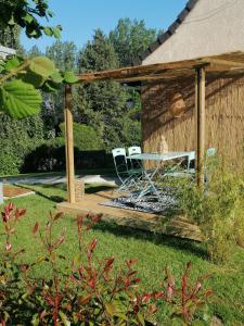 a gazebo with a table and chairs in a yard at Moulin Room in Naours