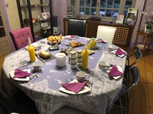 a table with a blue and white table cloth on it at La Collinière in Sainte-Gemme-Moronval