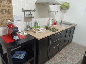 a kitchen with a sink and a counter top at B&B Epicarmo in Augusta