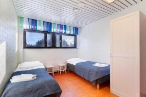 A bed or beds in a room at Imatra Spa Sport Camp