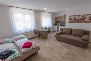 uma sala de estar com um sofá e uma mesa em Mona Apartman em Sárvár