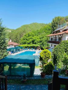 a view of a swimming pool in a resort at Комплекс Рожена, хотел, хотелски комплекс Рожена in Rozhen