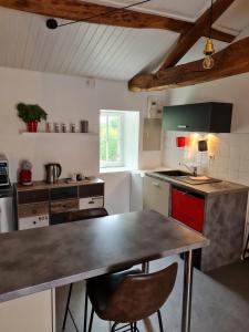 a kitchen with a table and two chairs in it at Gite "RIO", parking securise in La Roche-sur-Yon