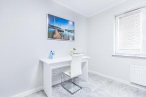 a white desk in a white room with a window at Apartament Nawigator Giżycko/Wilkasy in Wilkasy