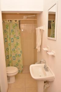 a bathroom with a sink and a toilet and a shower at Hotel Bugambilias in Ciudad Obregón