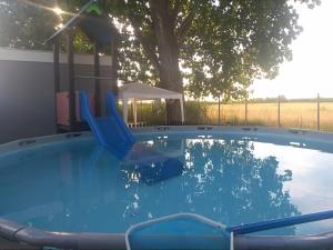 a swing in a swimming pool with a playground at VILLAGGIO degli ANGELI SCERNE PINETO in Scerne