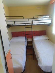 two bunk beds in a dorm room with white sheets at VILLAGGIO degli ANGELI SCERNE PINETO in Scerne +69 photos