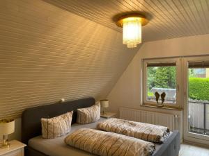 a bedroom with two beds and a window at Ferienwohnung Möwenblick in Flensburg