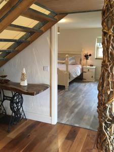 a bedroom with a bed and a table in a room at Mary's Bespoke Cottage in Killarney