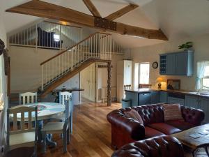 a living room with a couch and a table at Mary's Bespoke Cottage in Killarney
