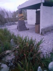 a stone patio with a fireplace in a yard at Mary's Bespoke Cottage in Killarney