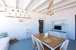 a dining room with a table and chairs at Amma Houses Sea View in Kalafatis