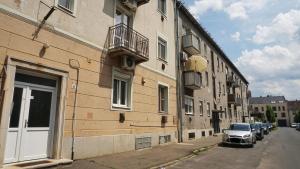 a car parked on a street next to a building at Belvarosi Exkluzív Minigarzon in Debrecen