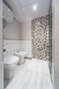 a bathroom with a toilet and a sink at Palazzo RICCA GUARDUCCI 1 in Montefiascone