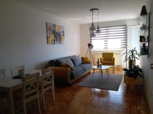 a living room with a couch and a table at Apartman M&S in Lukavica