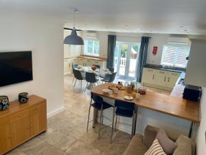 a kitchen and living room with a table and chairs at Number 15 in Norwich