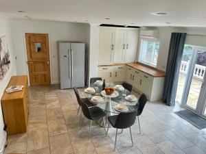a kitchen with a table and chairs and a refrigerator at Number 15 in Norwich +12 photos