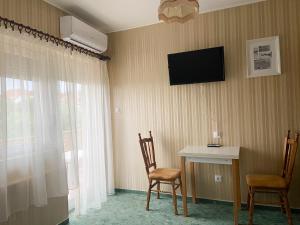 A television and/or entertainment centre at Piroska Apartment