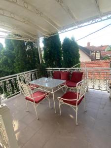 a patio with a table and chairs on a balcony at Gala Posh in Soko Banja