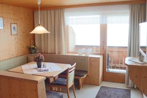 una cucina e una sala da pranzo con tavolo e sedie di Ferienpension Steiner a Weerberg
