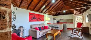 a living room with a couch and a kitchen at CASA LOS POLVEROS in Fuencaliente de la Palma