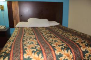 A bed or beds in a room at American Inn and Suites