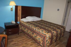 A bed or beds in a room at American Inn and Suites