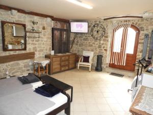 a bedroom with two beds and a tv on the wall at Zupan B studio apartman Krk in Krk