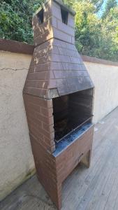 an outdoor brick oven sitting on a deck at Solar Alto Brava Buzios in Búzios