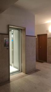 an empty room with a glass door in a building at Design apartment n. 41 in Trento