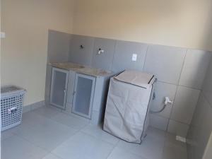 a small kitchen with a refrigerator and a counter at CASA TEMPORADA - PARA 05 PESSOAS in Trindade