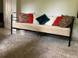 a couch with pillows on it in a living room at Garden apartment in Weston-super-Mare