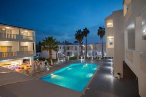 a swimming pool in the middle of a building at Princessa Vera Hotel Apartments in Paphos