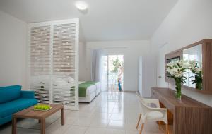 a living room with a blue couch and a table at Princessa Vera Hotel Apartments in Paphos