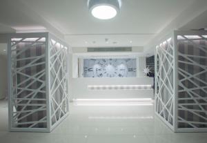 a room with two glass doors and a clock on the wall at Princessa Vera Hotel Apartments in Paphos