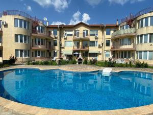 a large swimming pool in front of a building at Apartments in complex Daisy in Kranevo