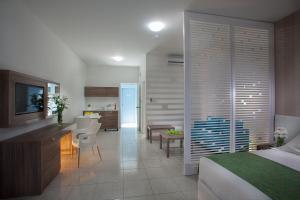 a bedroom with a bed and a kitchen and a dining room at Princessa Vera Hotel Apartments in Paphos