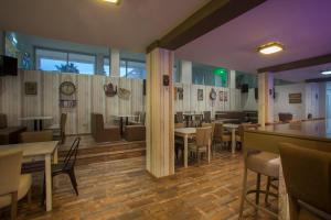 a restaurant with tables and chairs and a bar at Princessa Vera Hotel Apartments in Paphos